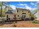 View of the backyard featuring a wooden deck with outdoor seating and well-maintained landscaping at 1100 Queensbury Cir, Durham, NC 27713