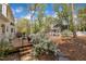 Backyard deck and landscaping, featuring azaleas, stone path and view of the screened in porch on neighboring house at 1100 Queensbury Cir, Durham, NC 27713