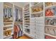Organized walk-in closet features custom shelves, hanging racks, drawers and handbag storage space at 1100 Queensbury Cir, Durham, NC 27713