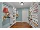 Walk-in closet with custom shelves for displaying decor and storing clothing and accessories at 1100 Queensbury Cir, Durham, NC 27713