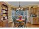 Cozy dining area features a round table with seating for four and a window overlooking the backyard at 1100 Queensbury Cir, Durham, NC 27713