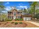 Brick two-story home featuring a well-manicured front yard, black shutters, and an attached two-car garage at 1100 Queensbury Cir, Durham, NC 27713