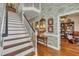 Bright foyer with wallpaper, hardwood floors, and a staircase leading to the second floor at 1100 Queensbury Cir, Durham, NC 27713