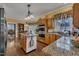 Kitchen with wood cabinets, granite counters, stainless appliances, and island cooktop at 1100 Queensbury Cir, Durham, NC 27713