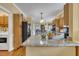 Spacious kitchen featuring granite counters, wooden cabinetry and view to dining room at 1100 Queensbury Cir, Durham, NC 27713