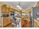 Spacious kitchen with wooden cabinets, stainless steel appliances, granite counters and a central island at 1100 Queensbury Cir, Durham, NC 27713