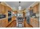 Spacious kitchen with wooden cabinets, stainless steel appliances, granite counters and a central island at 1100 Queensbury Cir, Durham, NC 27713
