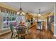 Bright kitchen and dining area showcasing hardwood floors, a window, and modern appliances at 1100 Queensbury Cir, Durham, NC 27713