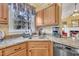 Kitchen with granite counters, wood cabinets, and stainless steel appliances, with view to living area at 1100 Queensbury Cir, Durham, NC 27713
