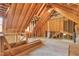 Unfinished attic space showcasing exposed wooden beams, providing potential for a bonus room or additional storage at 117 Vicksburg Dr, Cary, NC 27513