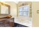 Inviting bathroom with a soaking tub and a stylish vessel sink with custom cabinetry at 117 Vicksburg Dr, Cary, NC 27513