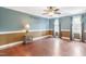 Spacious bedroom with hardwood floors, a ceiling fan, and natural light at 117 Vicksburg Dr, Cary, NC 27513