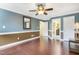 Spacious bedroom featuring hardwood floors, neutral paint, and ensuite bathroom access at 117 Vicksburg Dr, Cary, NC 27513