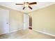 Bedroom with neutral carpet, beige walls, a ceiling fan, and white trim at 117 Vicksburg Dr, Cary, NC 27513