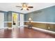 Large bedroom with hardwood floors, ceiling fan, and neutral two tone paint scheme at 117 Vicksburg Dr, Cary, NC 27513