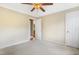 Neutral bedroom featuring a ceiling fan, beige walls, carpet, and white trim at 117 Vicksburg Dr, Cary, NC 27513