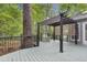 Exterior deck showcasing a pergola, and a large tree offering partial shade, perfect for outdoor relaxation and gatherings at 117 Vicksburg Dr, Cary, NC 27513