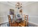 Elegant dining room with stylish chandelier, glass top table, and zebra print runner at 117 Vicksburg Dr, Cary, NC 27513
