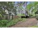 Exterior view of a home featuring a deck, mature trees, and lush landscaping, creating a serene and private setting at 117 Vicksburg Dr, Cary, NC 27513