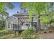 Back exterior of home featuring a deck, a pergola, and lush greenery, offering a perfect blend of indoor-outdoor living at 117 Vicksburg Dr, Cary, NC 27513
