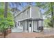 Exterior view of home featuring a brick patio, a pergola, and well-maintained landscaping, perfect for outdoor entertaining at 117 Vicksburg Dr, Cary, NC 27513