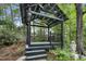 Charming gazebo in a wooded yard with decorative details and offering a tranquil outdoor retreat at 117 Vicksburg Dr, Cary, NC 27513