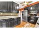 Kitchen featuring stainless steel appliances, dark cabinets, warm colored walls and hardwood floors at 117 Vicksburg Dr, Cary, NC 27513