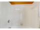 Clean white tiled shower and tub combination with neutral fixtures and orange accent paint at 117 Vicksburg Dr, Cary, NC 27513