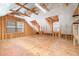 Large unfinished attic space with exposed wood framing and windows at 1208 Lexington Farm Rd, Apex, NC 27502