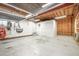Unfinished basement space featuring concrete floors and exposed ceiling at 1208 Lexington Farm Rd, Apex, NC 27502