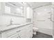 Renovated bathroom with white tiles, modern fixtures, and granite countertop at 1208 Lexington Farm Rd, Apex, NC 27502