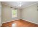Sunny bedroom with hardwood floors, ceiling fan and large window at 1208 Lexington Farm Rd, Apex, NC 27502