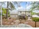Charming home exterior featuring a screened porch, brick patio and blossoming plants at 1208 Lexington Farm Rd, Apex, NC 27502