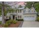 Charming two-story home with brick accents, dormer windows, and a well-manicured lawn at 1208 Lexington Farm Rd, Apex, NC 27502