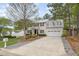 Inviting home exterior with a long driveway, attached garage, and manicured front lawn at 1208 Lexington Farm Rd, Apex, NC 27502