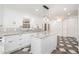 Modern kitchen with white cabinets, granite countertops, an island, and stylish flooring at 1208 Lexington Farm Rd, Apex, NC 27502