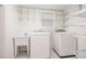 Clean and organized laundry room with ample shelving and modern appliances at 1208 Lexington Farm Rd, Apex, NC 27502
