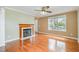 Cozy living room featuring a fireplace, hardwood floors, and plenty of natural light at 1208 Lexington Farm Rd, Apex, NC 27502
