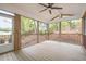 Relaxing screened in porch featuring a ceiling fan and garden views at 1208 Lexington Farm Rd, Apex, NC 27502