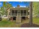 Back exterior showing a screened-in porch, and steps leading down to a large backyard perfect for entertaining at 124 Mantle Dr, Clayton, NC 27527