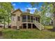 Back exterior featuring a screened-in porch with views of neighboring homes and mature shade trees at 124 Mantle Dr, Clayton, NC 27527