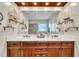 Bright bathroom features a double sink vanity, decorative shelves, and a large mirror reflecting natural light at 124 Mantle Dr, Clayton, NC 27527