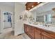 Bathroom featuring double vanity with white countertops, tile flooring, natural lighting, and walk-in closet at 124 Mantle Dr, Clayton, NC 27527