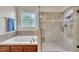 Bright bathroom features a tub, a tiled shower, and a window at 124 Mantle Dr, Clayton, NC 27527