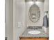 Well-lit half bath with granite countertops and decorative mirror at 124 Mantle Dr, Clayton, NC 27527