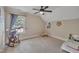 Cozy bedroom featuring a ceiling fan and a bright window with a stuffed animal rocking chair at 124 Mantle Dr, Clayton, NC 27527