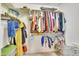 Well-organized walk-in closet with double-hung rods for ample storage and a variety of clothing items at 124 Mantle Dr, Clayton, NC 27527