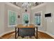 Dining area with a view, hardwood floors, a decorative chandelier, and three windows to create natural light at 124 Mantle Dr, Clayton, NC 27527