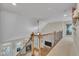 Hallway features wooden railings, fireplace, and lots of natural light at 124 Mantle Dr, Clayton, NC 27527