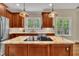 Bright kitchen with stainless steel appliances, granite countertops, backsplash, and light from double windows at 124 Mantle Dr, Clayton, NC 27527